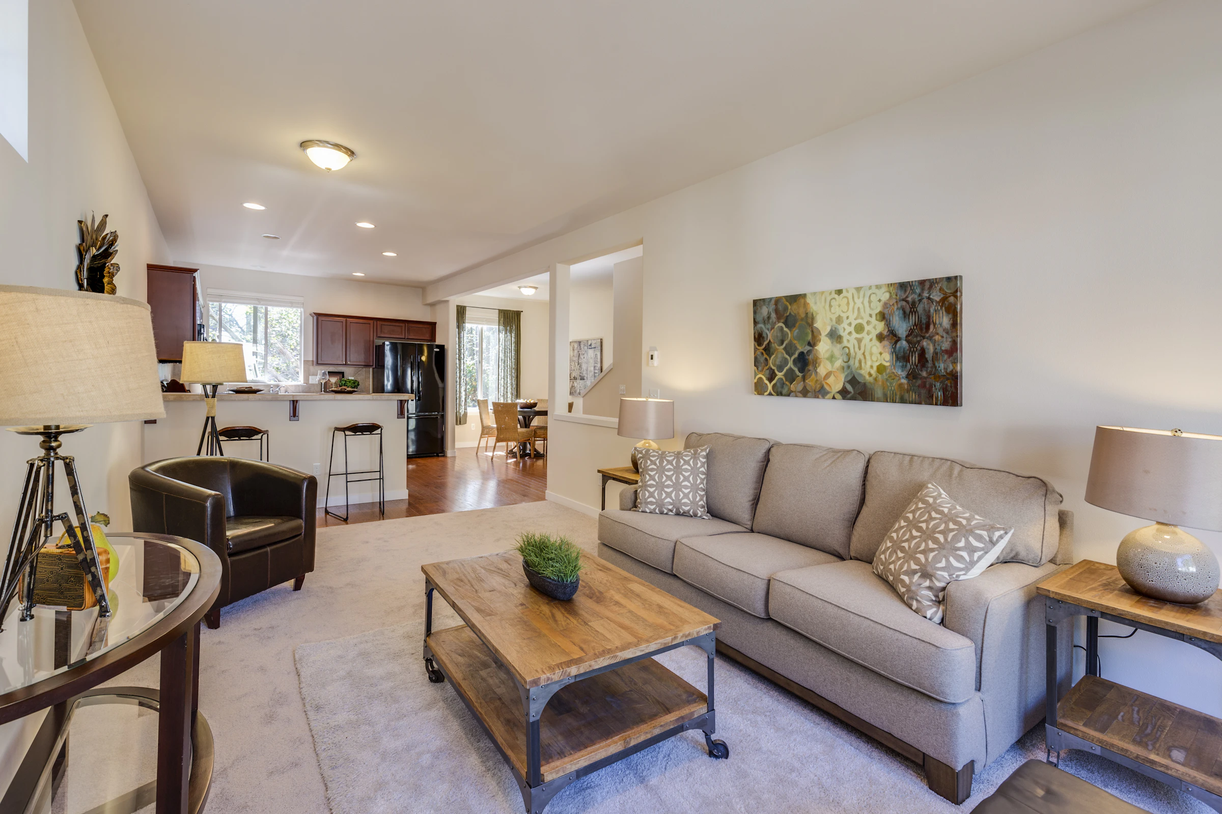 Warm modern living room with coordinated furniture, lighting, and home decor