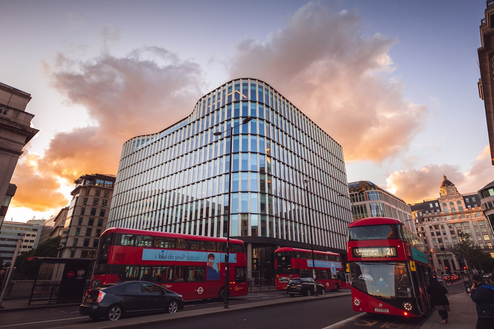 red bus beside curtain wall building