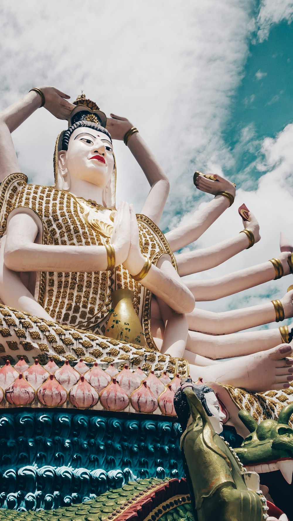 gold and beige Hindu deity statue