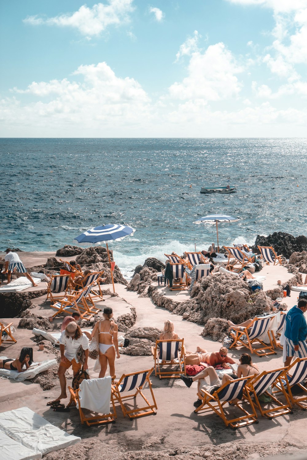 people standing near beach line