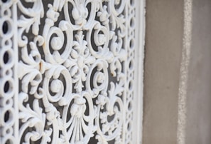 Close-up of decorative wrought iron pergola with intricate metalwork details