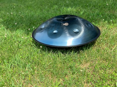 round gray firepit on grass