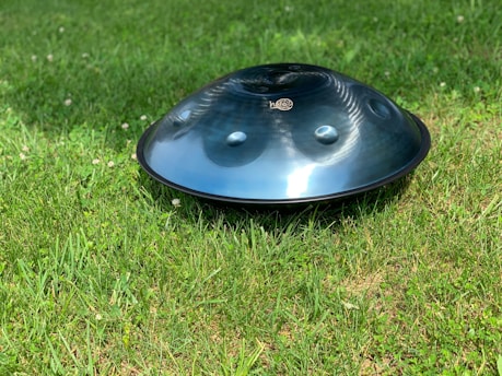 round gray firepit on grass