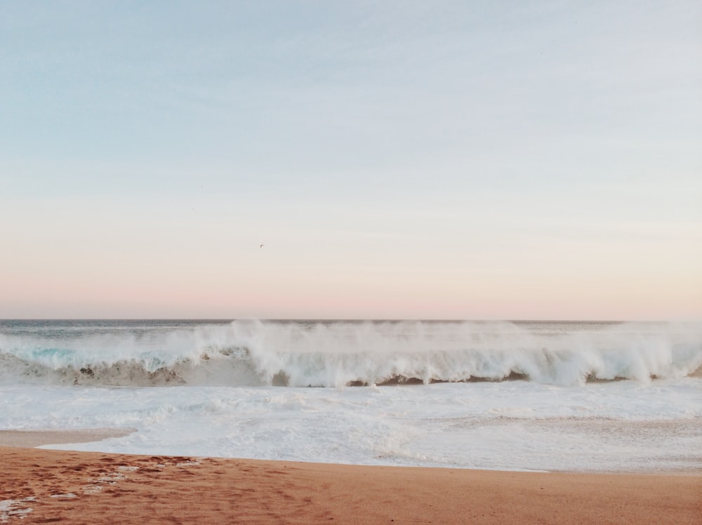 time lapse photography of waves on seashore during daytime