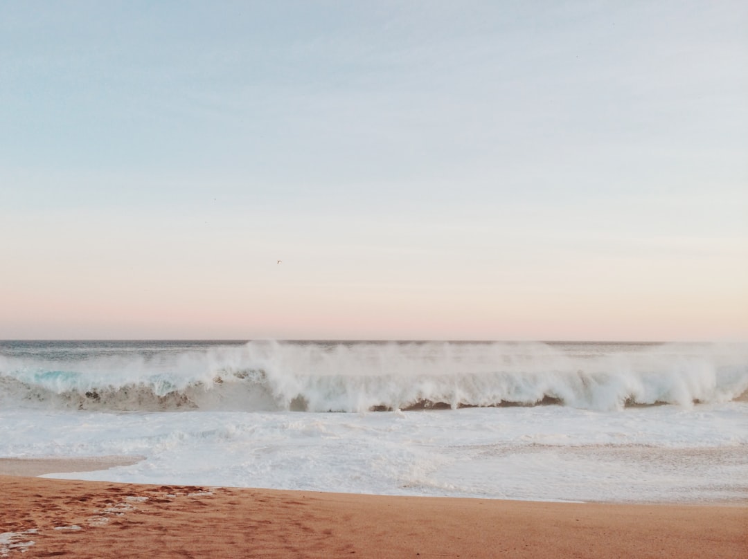 time lapse photography of waves on seashore during daytime