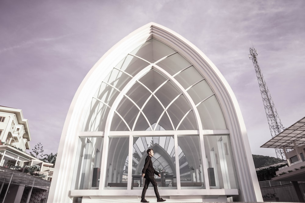 man standing beside building