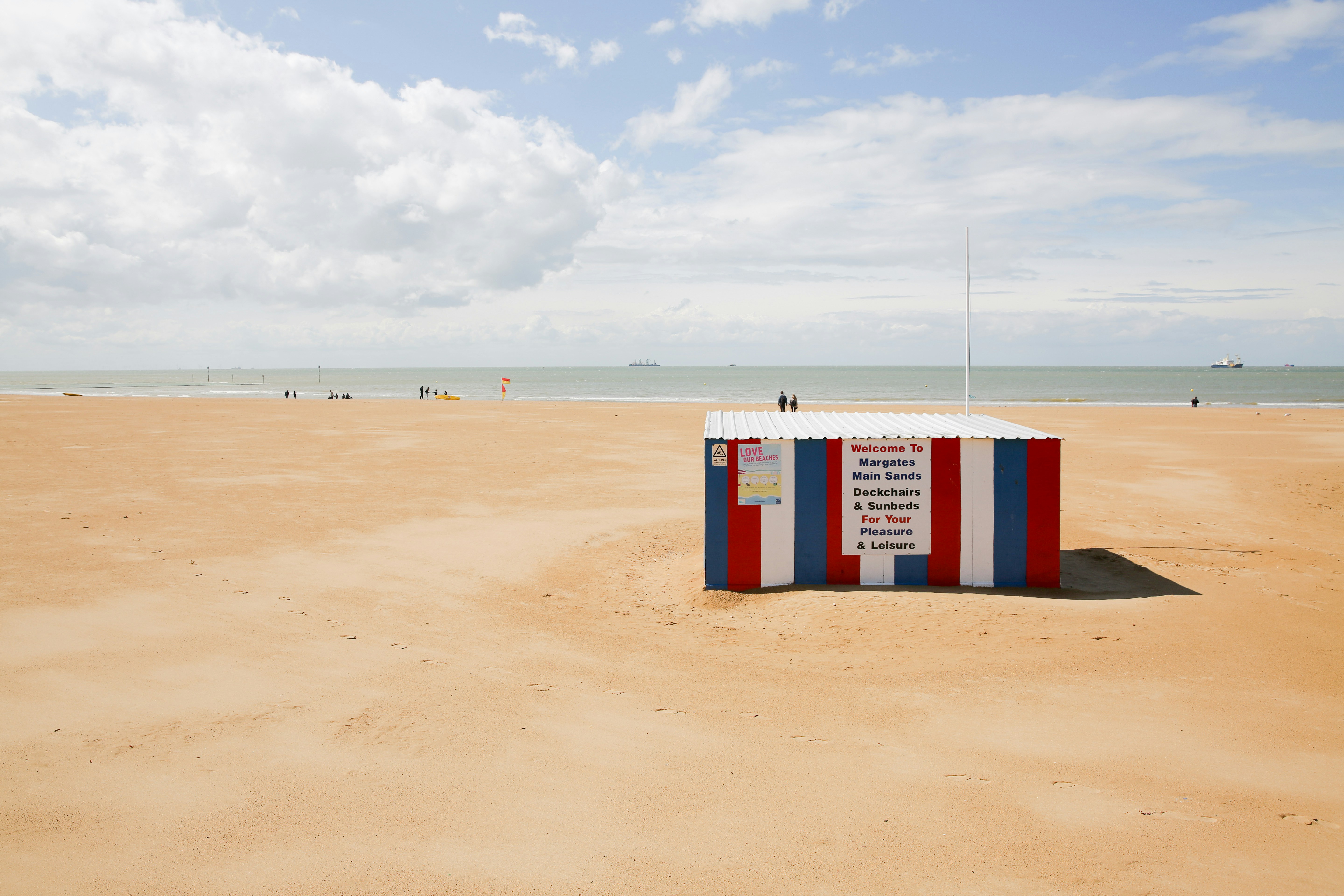 red and white concrete container during daytime, 