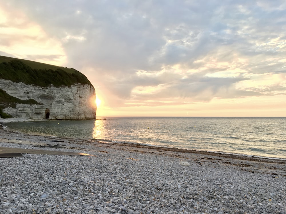 rock formation near body of water during daytime