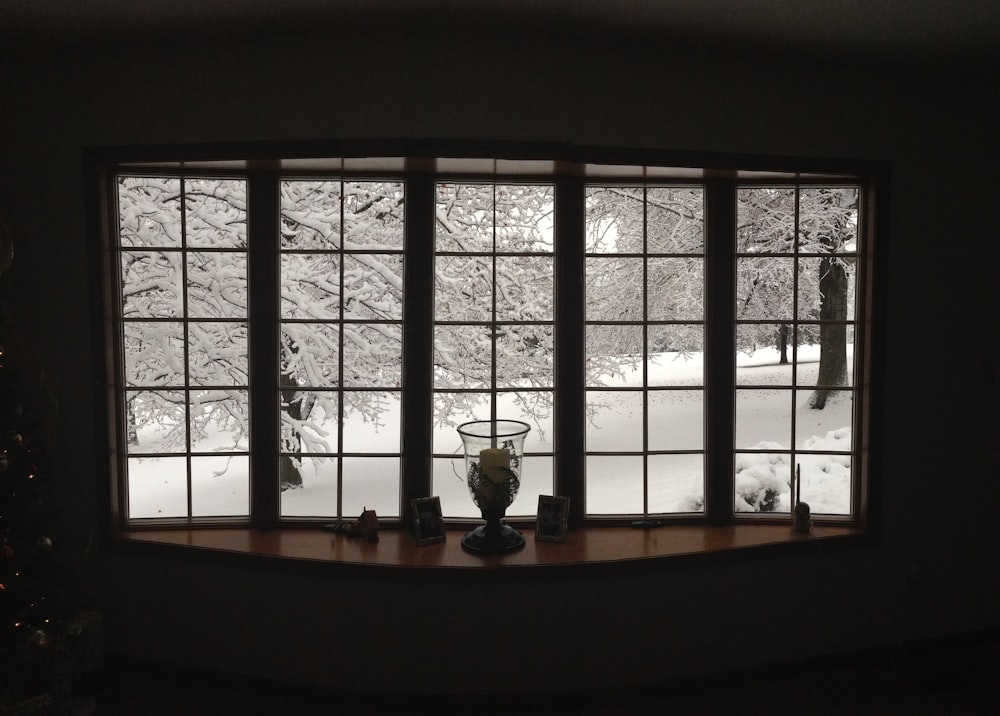 clear glass vase beside glass window during winter