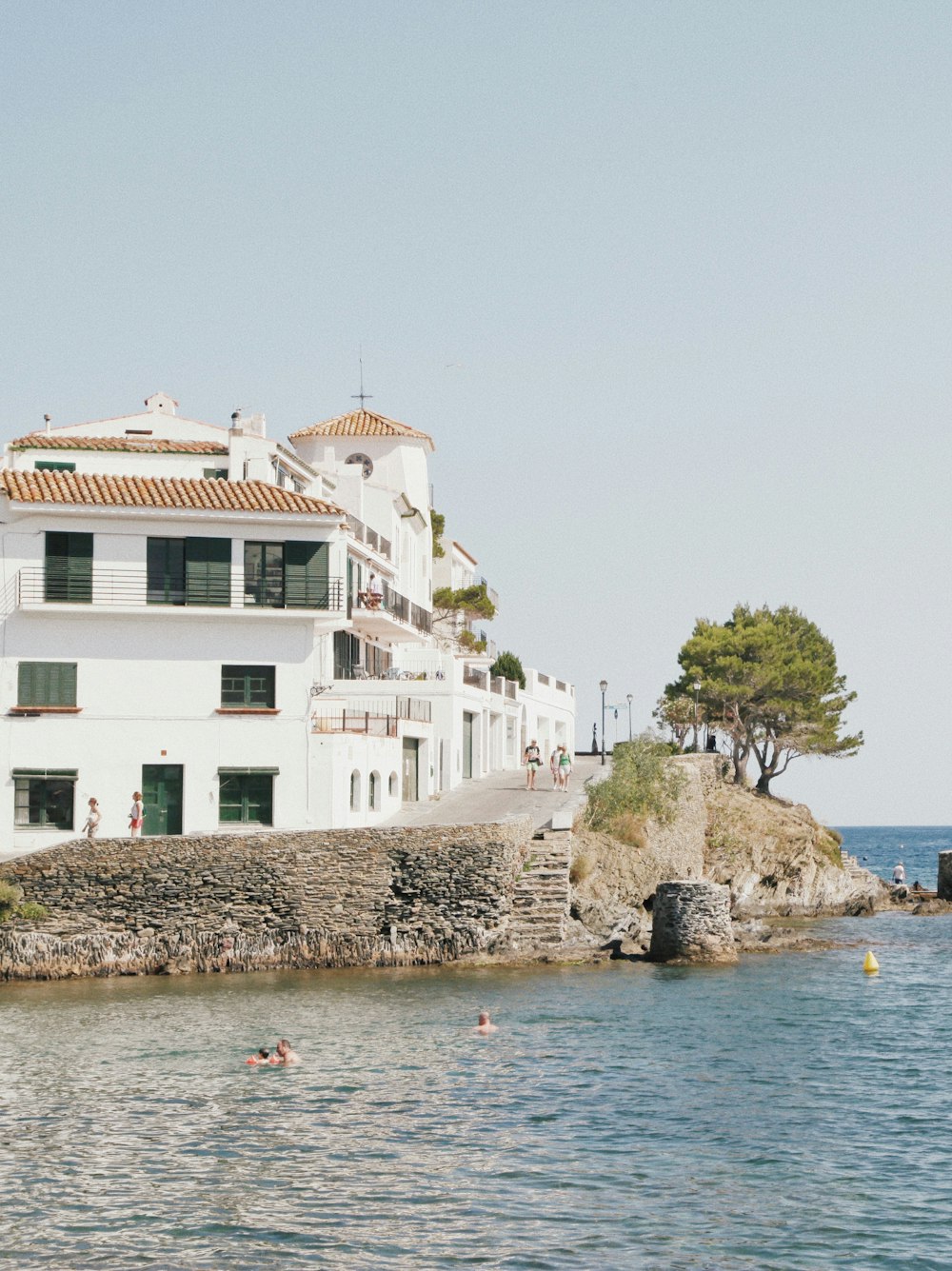 white concrete building beside body of water