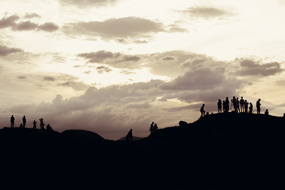 a group of people standing on top of a hill