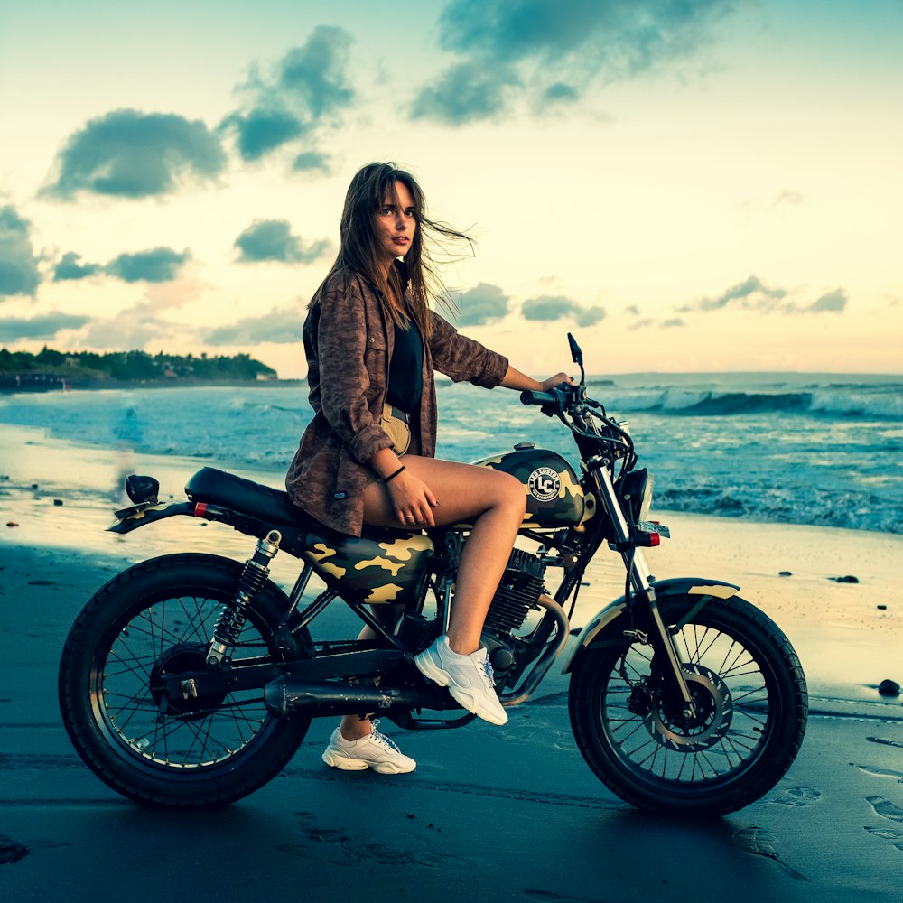 woman riding motorcycle near seashore