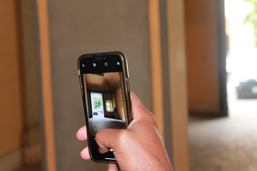 person holding black smartphone