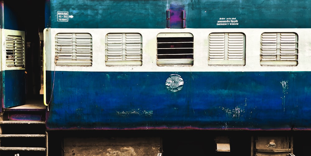 blue, white, and green train coach