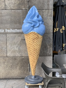 A colorful display of assorted ice cream cones and chilled beverages on a sunny day