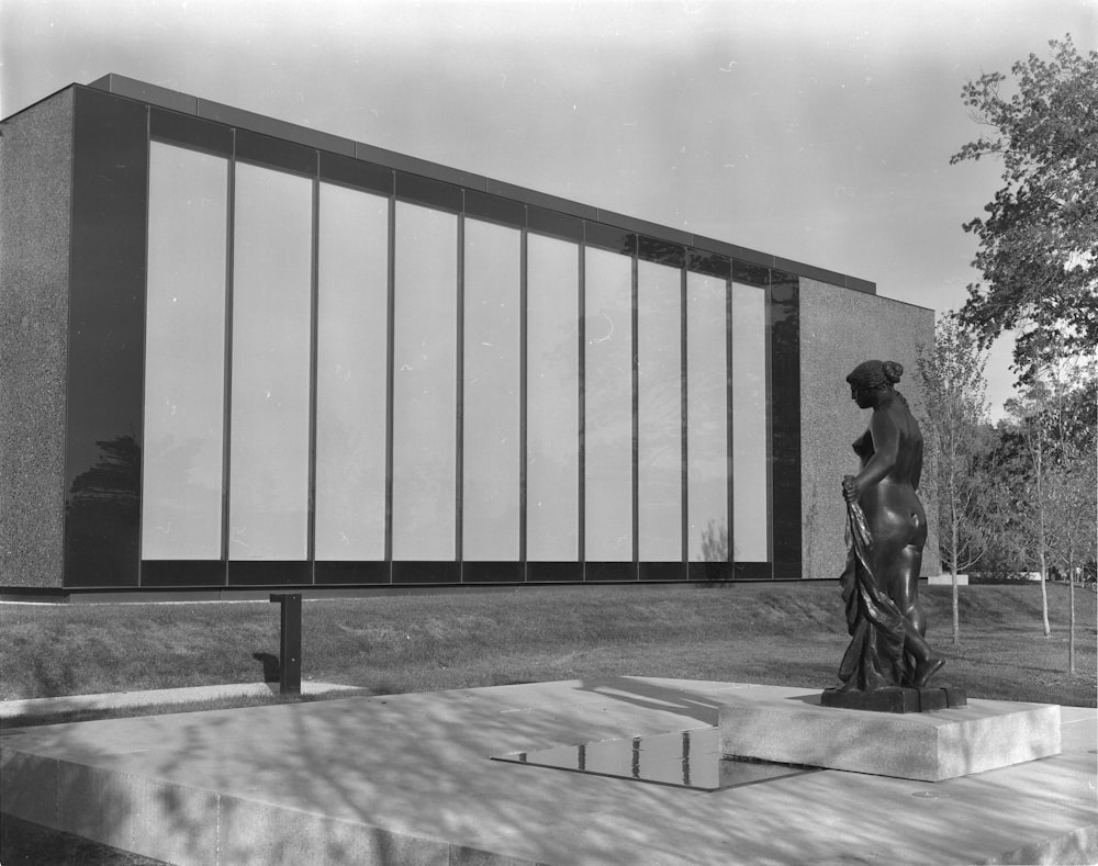 nude woman statue in front of building