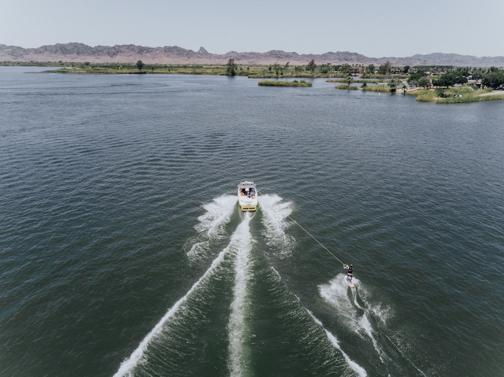 time lapse photography of speedboat passing on body of water