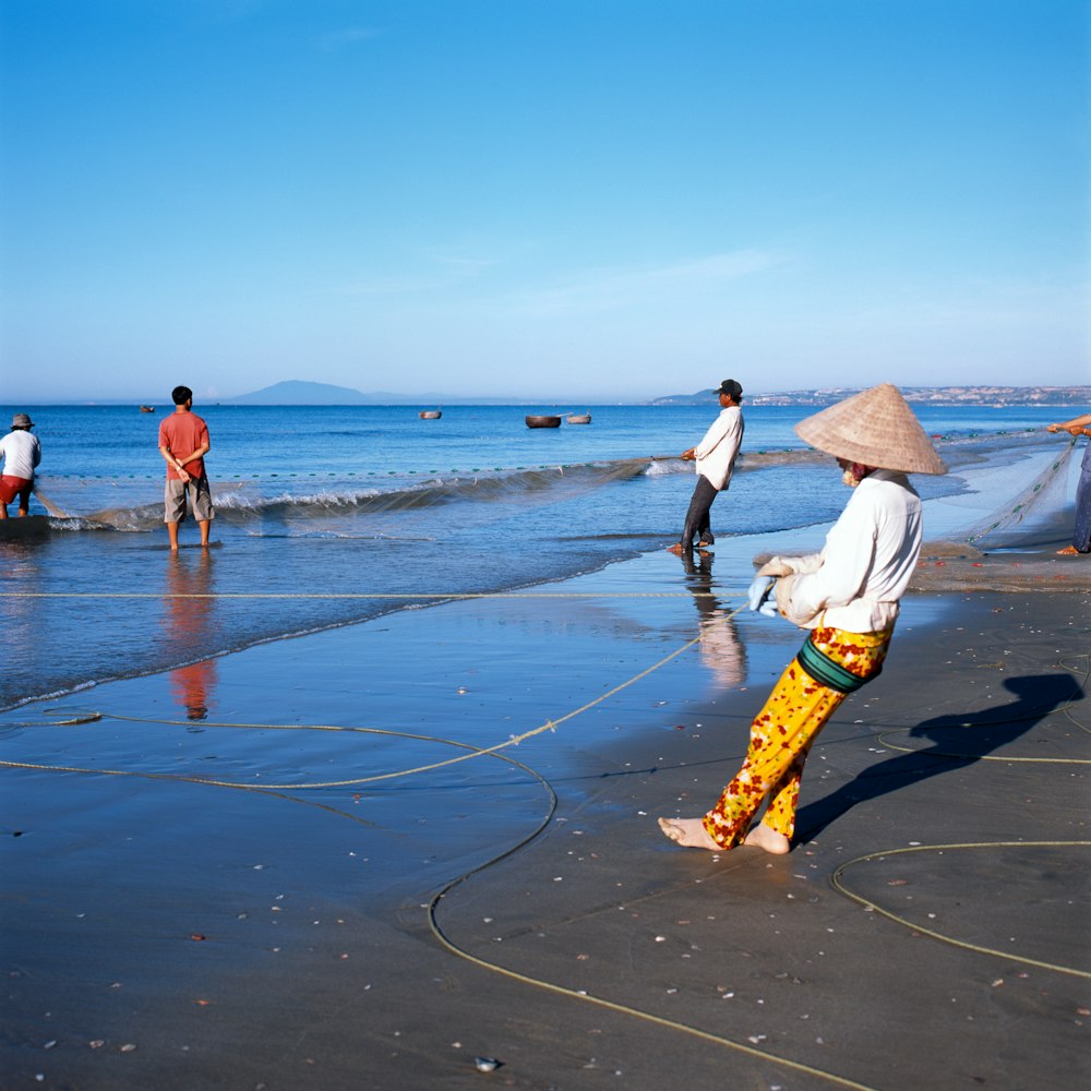 a person on a beach with a hat on