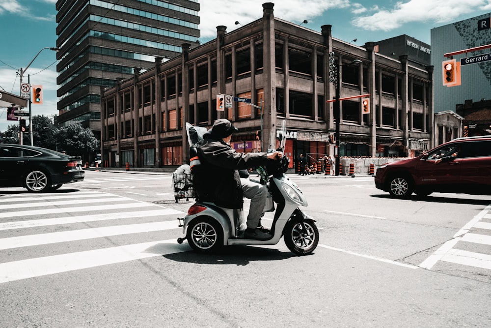 man riding motor scooter