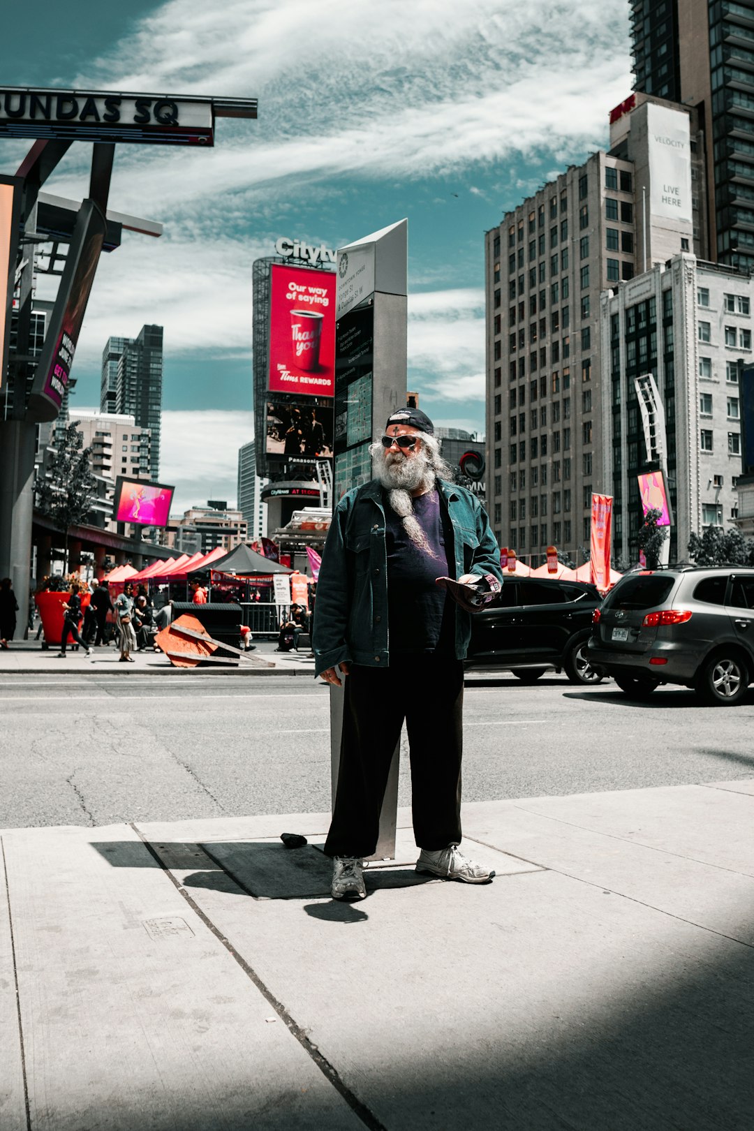 man standing beside road on focus photography