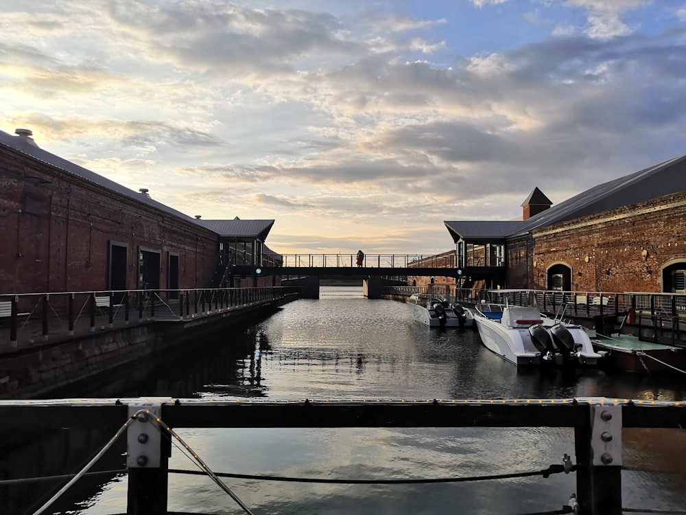 a boat is docked next to a brick building