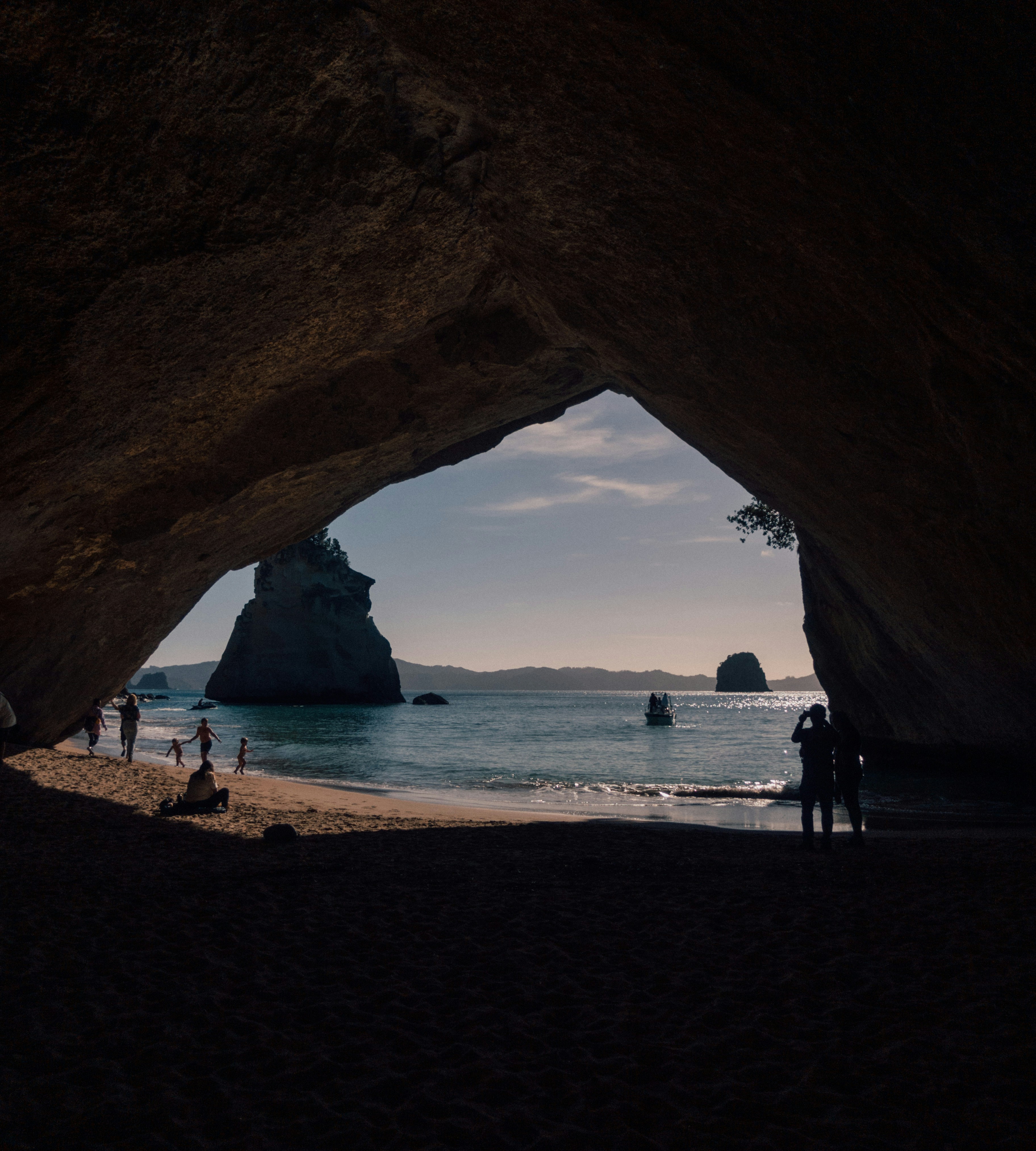 cave leading to a white sand beach