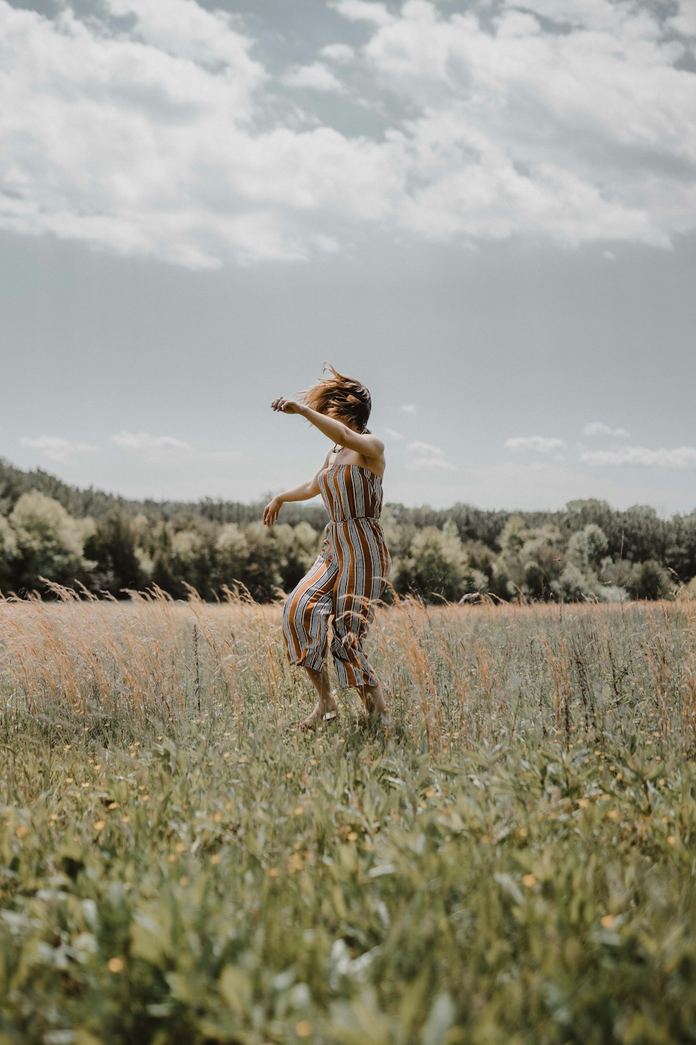 woman in grass field during daytime