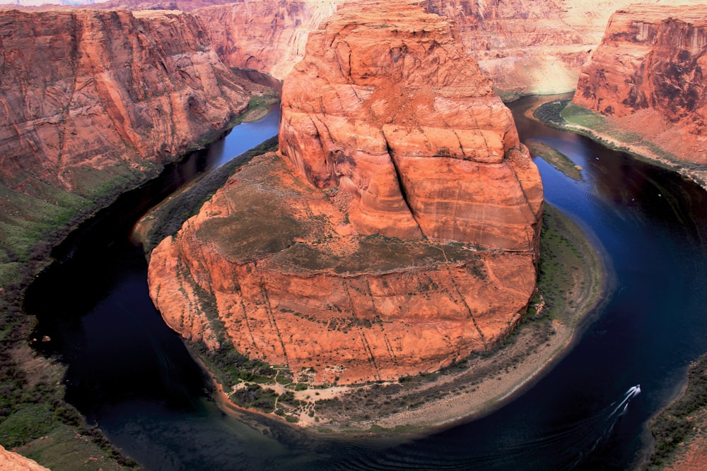 aerial photo of rock formation surrounded by body of water