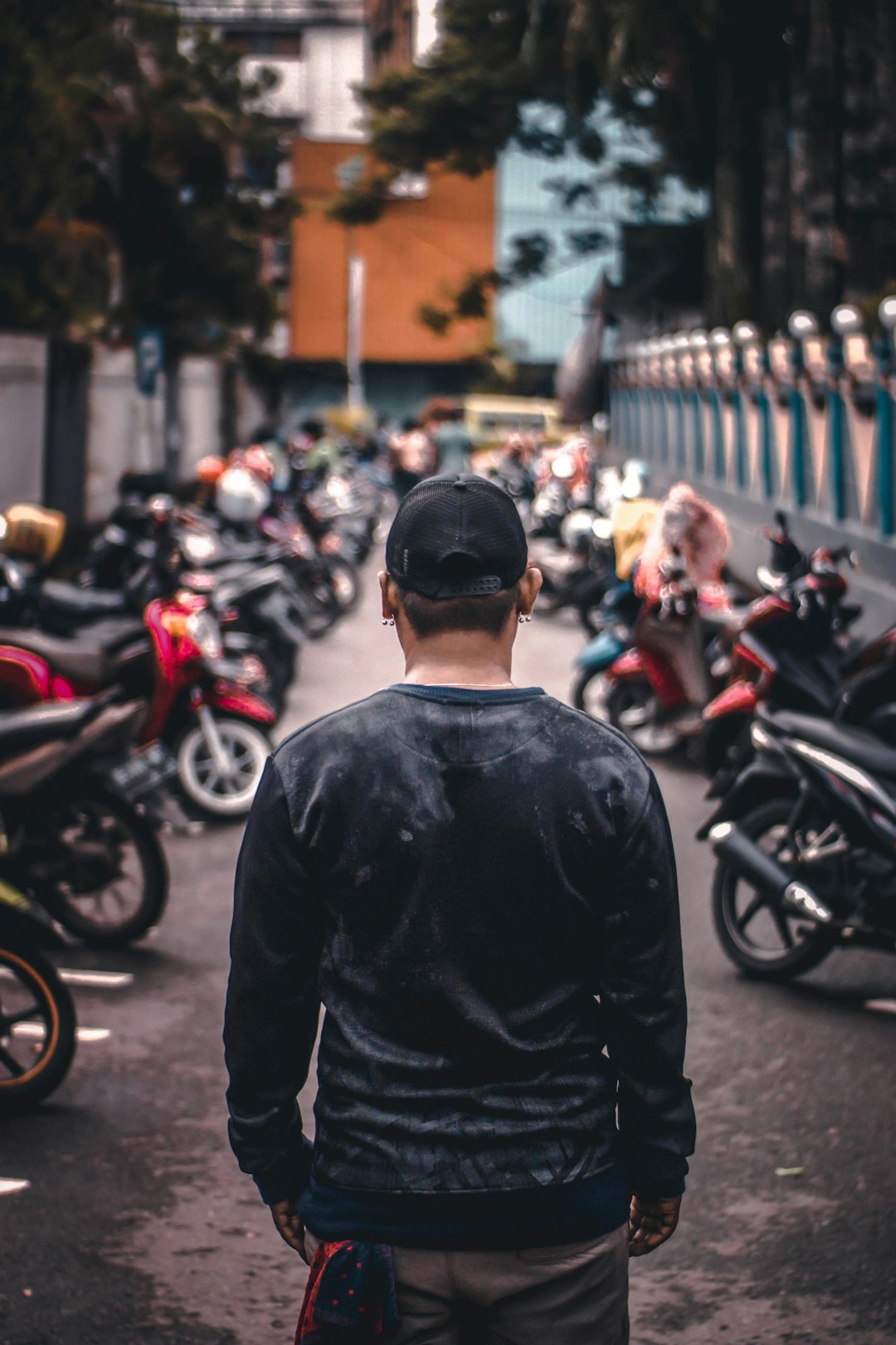 man standing in front of parked motorcycles