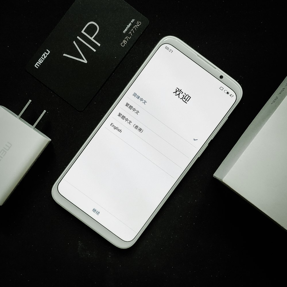white smartphone beside white box