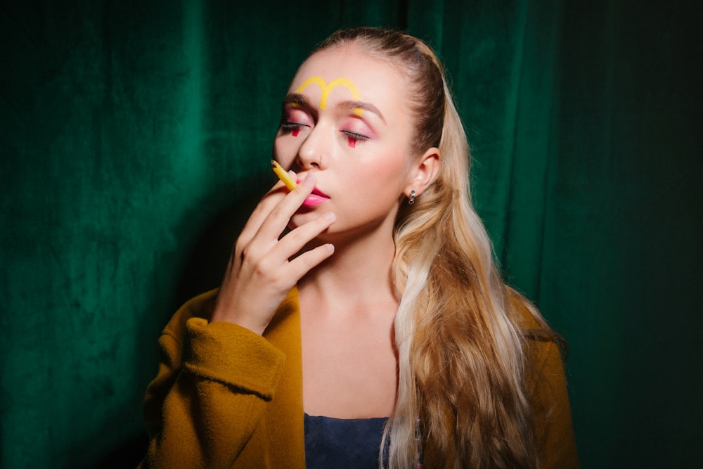 woman in yellow cardigan smoking a cigarette