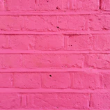A detailed shot of textured paint on a minimalist artwork with powder pink highlights.