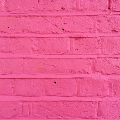Close-up of a colorful 3D print on a brick wall highlighting texture.