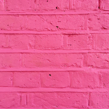 Close-up of a colorful 3D print on a brick wall highlighting texture.