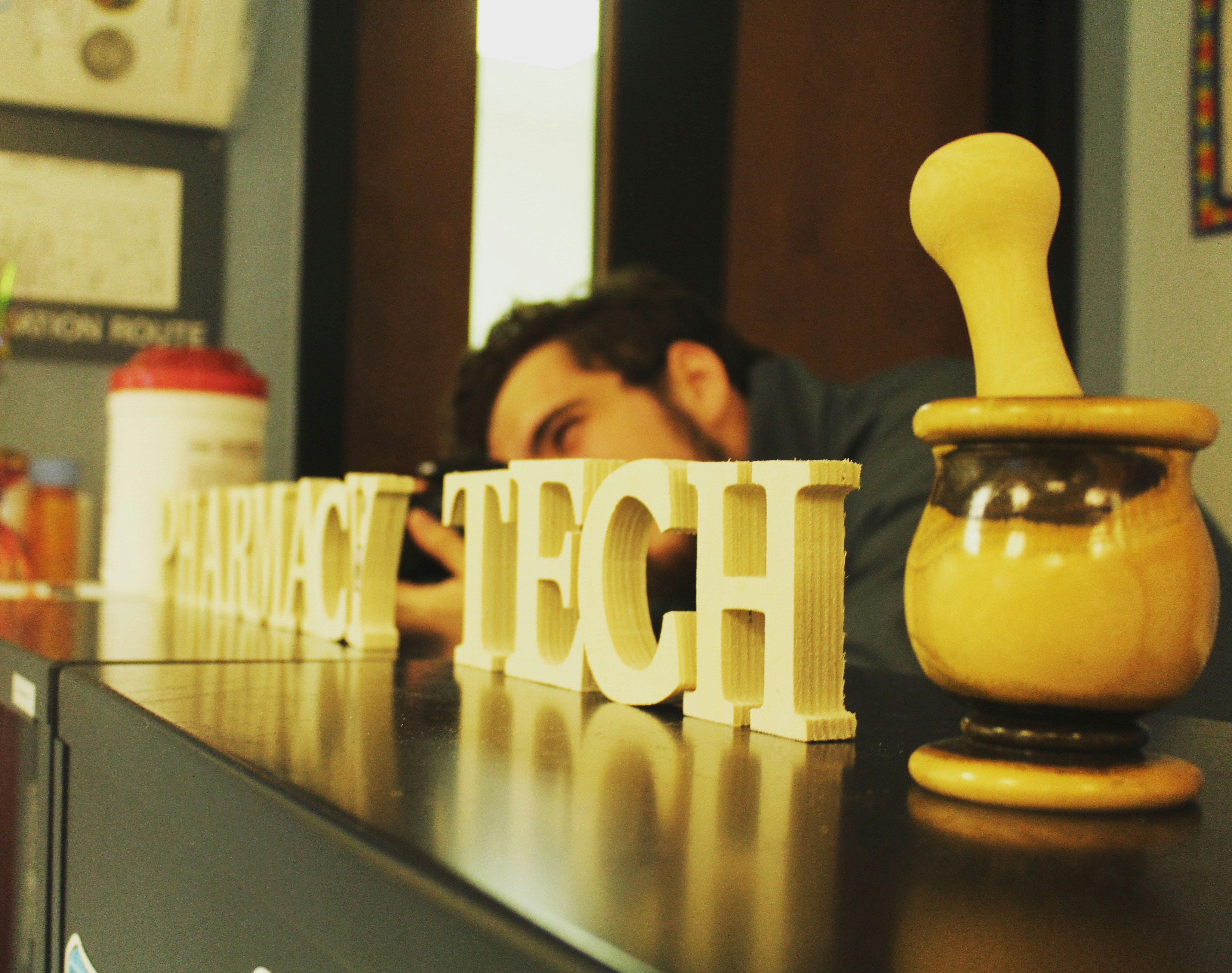 man sitting at the table near wooden signs