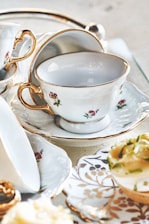 A beautifully arranged high tea set with delicate pastries and tea.