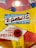 A retro design with colorful graphics featuring a logo for D. Gottlieb & Co. It includes playful illustrations of birds and a red button labeled 'WHEN LIT'. The text also indicates the company's location in Chicago, Illinois. The color palette is a mix of bright yellow, red, and blue.