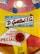 A retro design with colorful graphics featuring a logo for D. Gottlieb & Co. It includes playful illustrations of birds and a red button labeled 'WHEN LIT'. The text also indicates the company's location in Chicago, Illinois. The color palette is a mix of bright yellow, red, and blue.