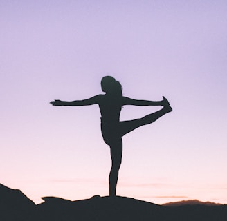 silhouette of woman doing yoga
