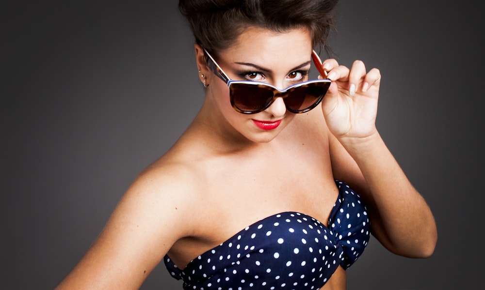 woman wearing sunglasses and polka-dot brassiere