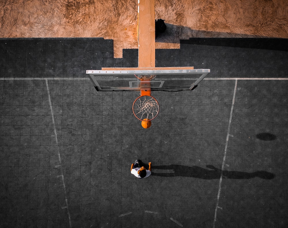 person playing basketball at basketball court