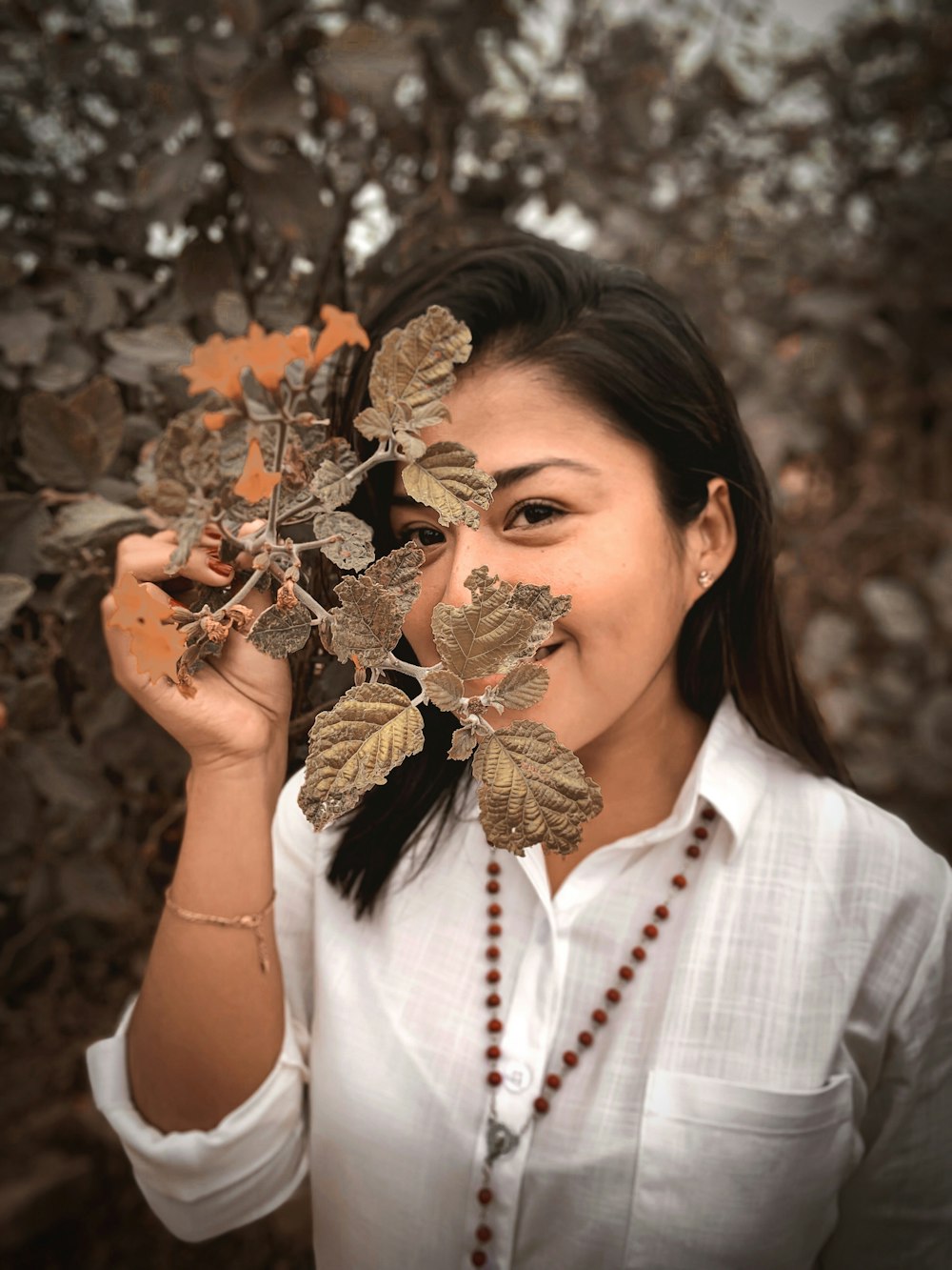 woman wearing brown leaf plant