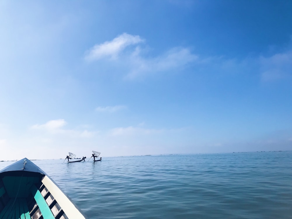 a couple of boats floating on top of a large body of water