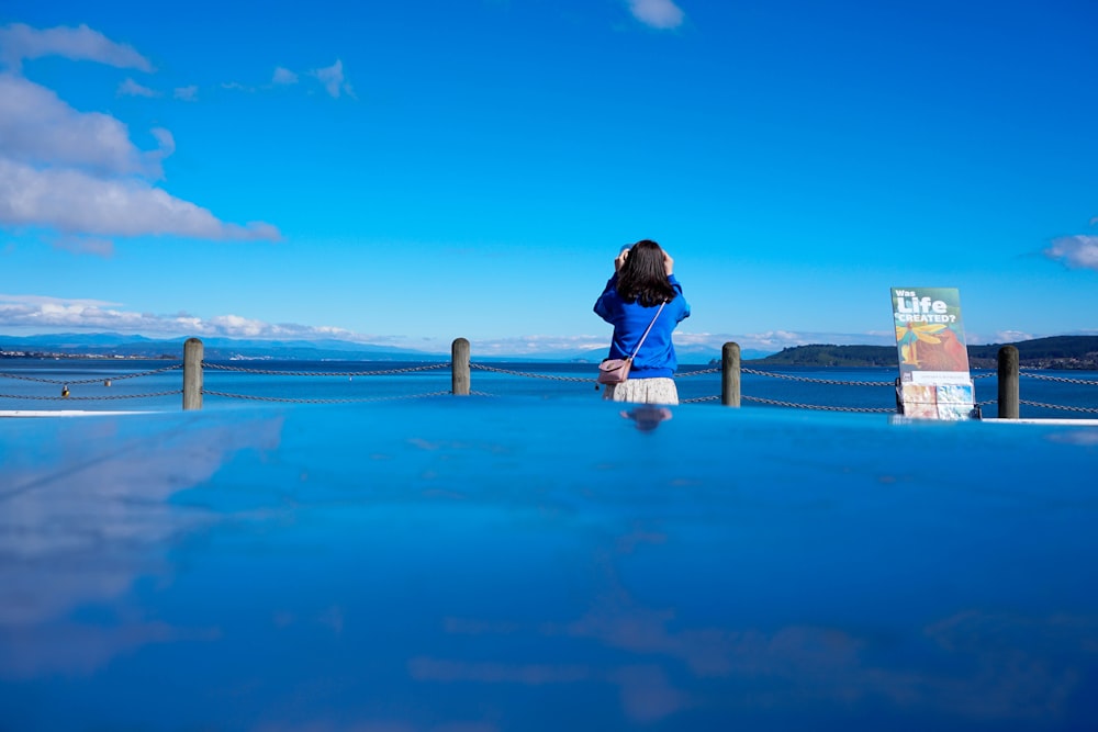 woman standing beside sea