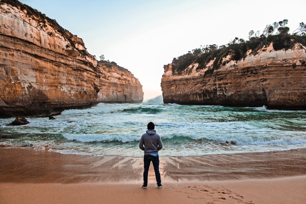 unknown person standing near body of water