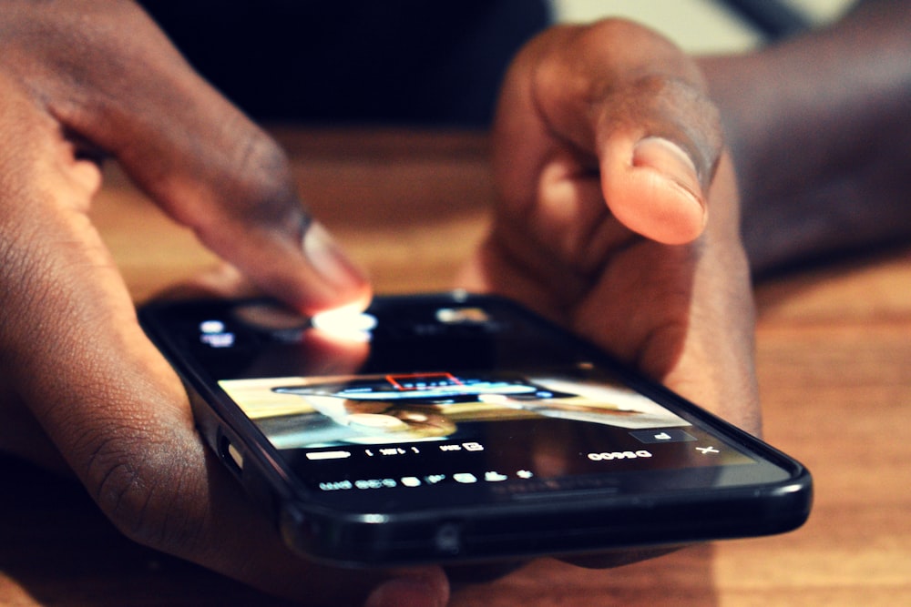 close-up photography of person using smartphone