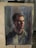 A detailed watercolor portrait of a person with short hair, displayed on an easel. The painting uses dark and muted colors, creating a dramatic and introspective atmosphere.