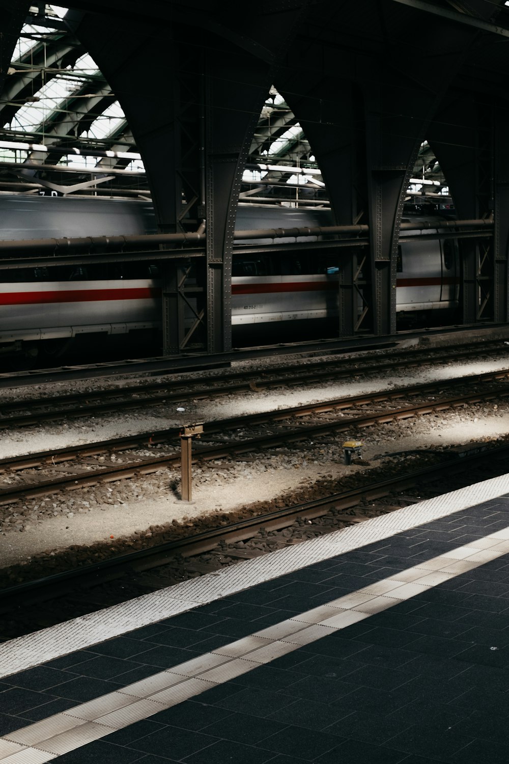 a train traveling through a train station next to a platform