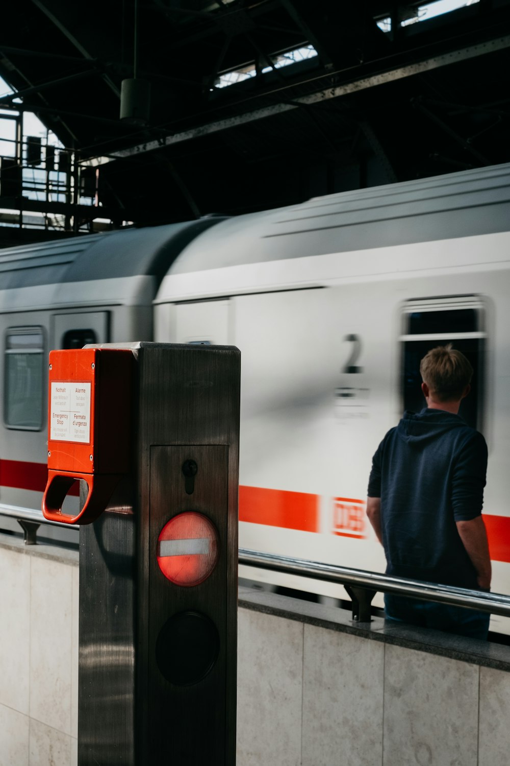 unknown person standing near white and gray train