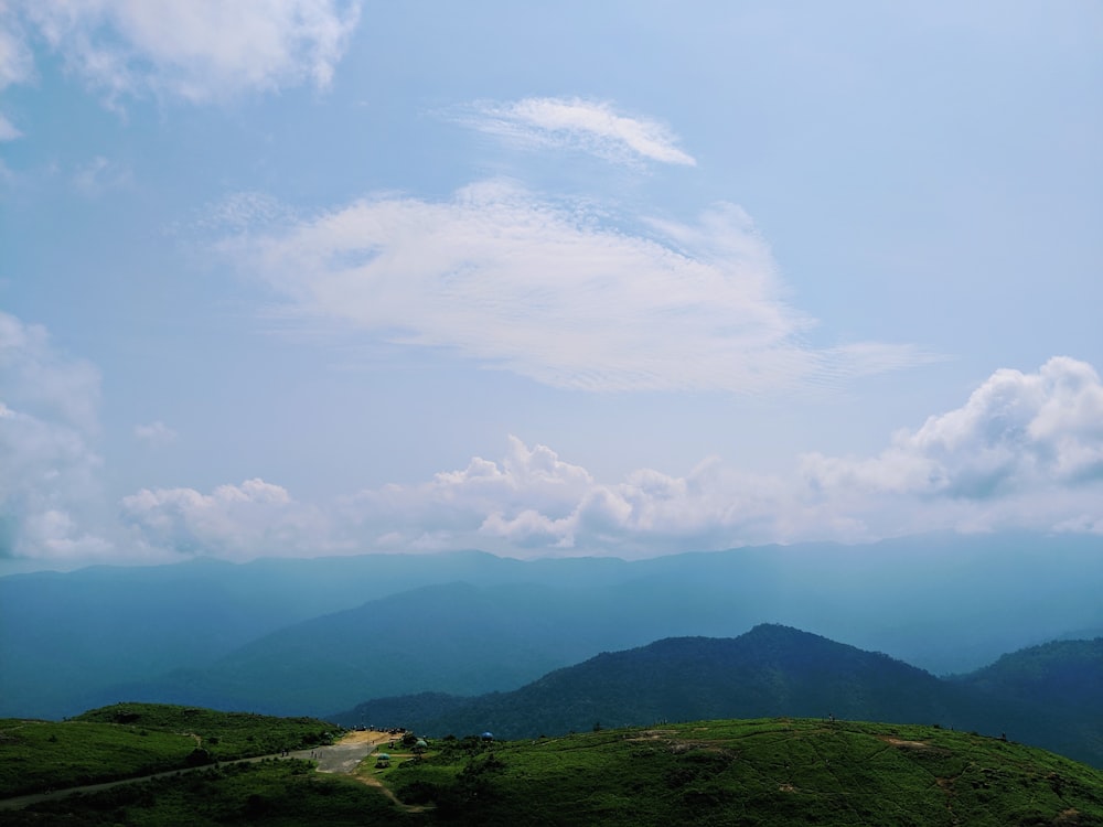 green hill and clouds